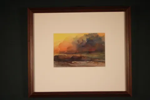 Original framed watercolor Low Tide by Sherry H. Holmes, depicting a coastal landscape with exposed shoreline, remaining water, and warm orange and brown earth tones beneath an atmospheric sky.